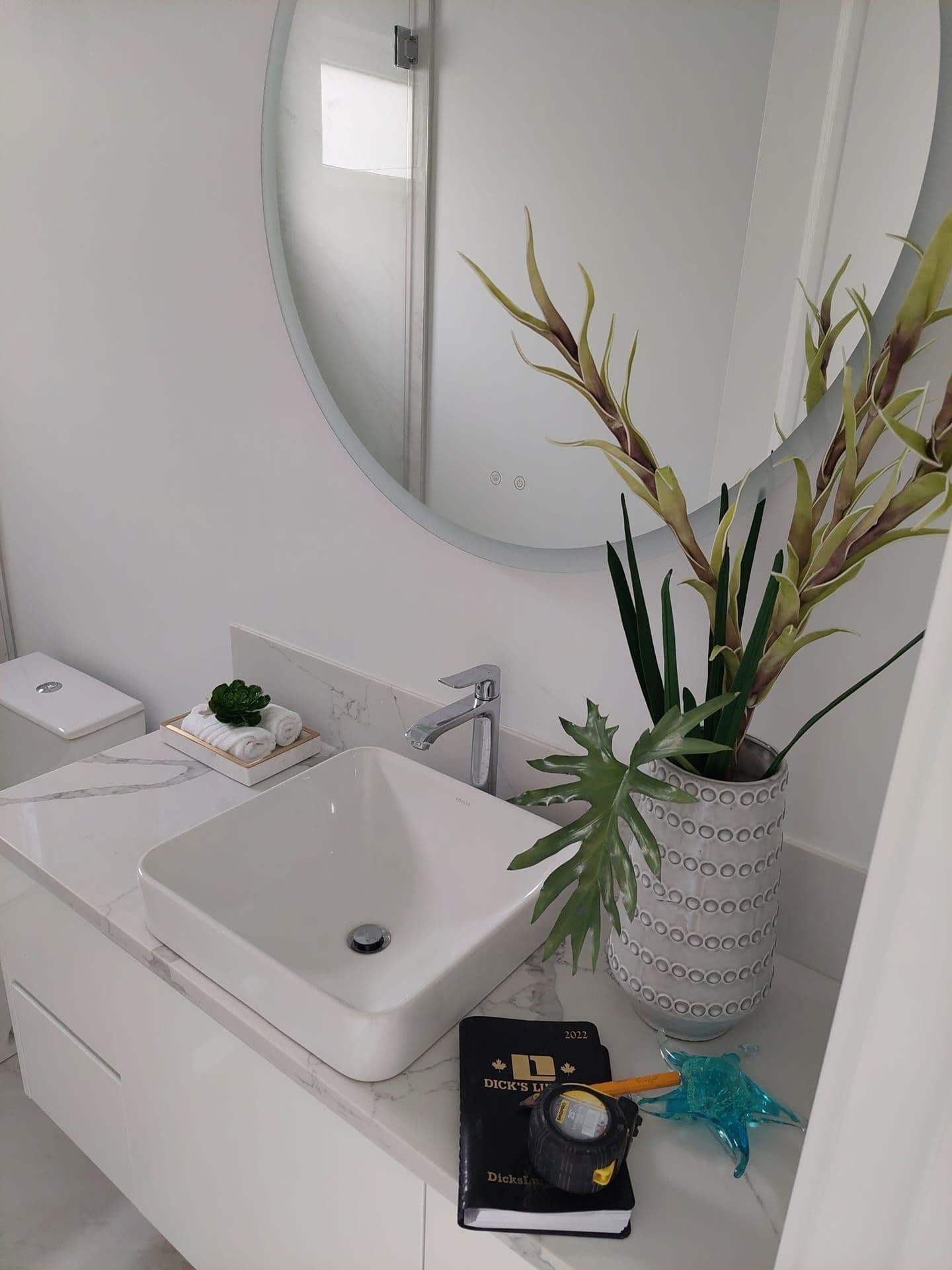 Bathroom vanity with marble countertop and LED mirror