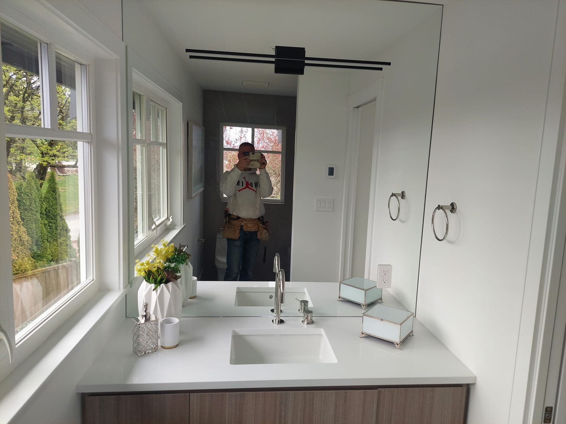 Bathroom finishing with modern vanity and natural light