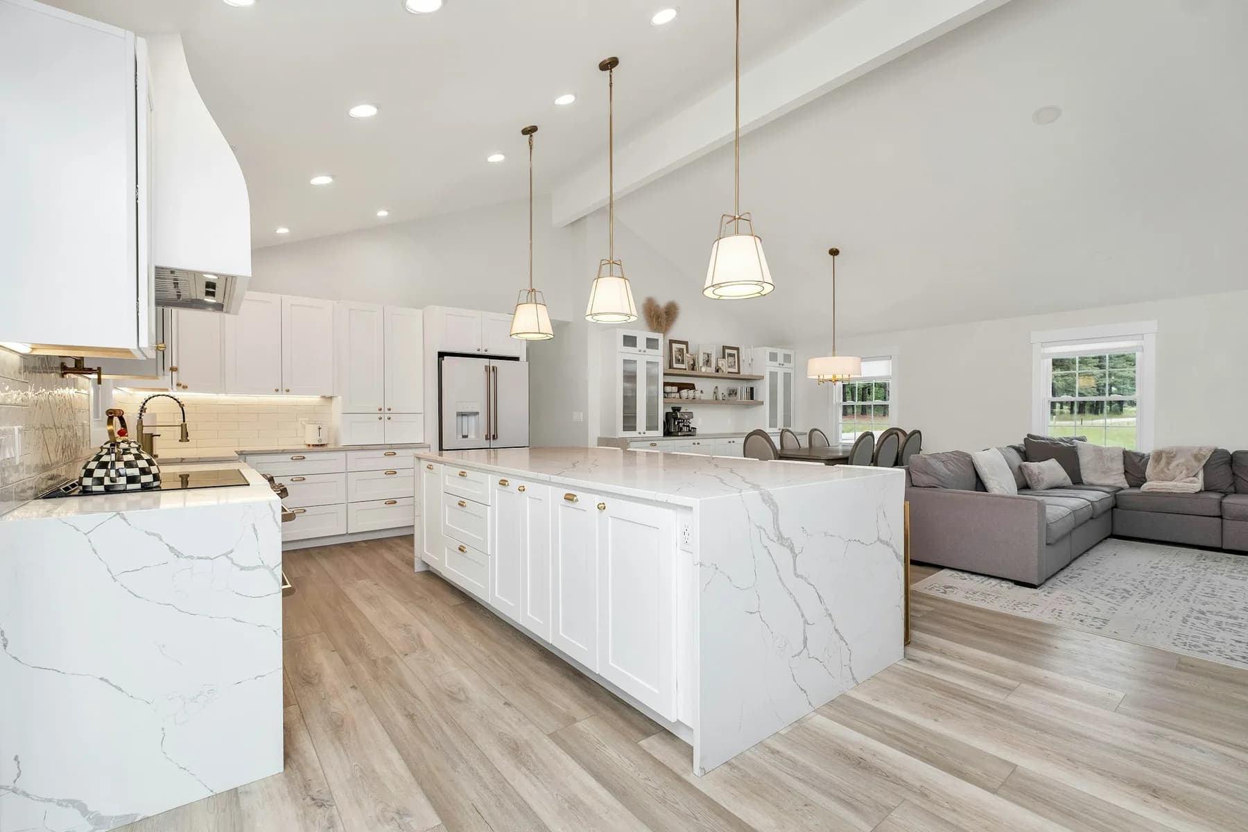 Kitchen island and hood with living area beyond