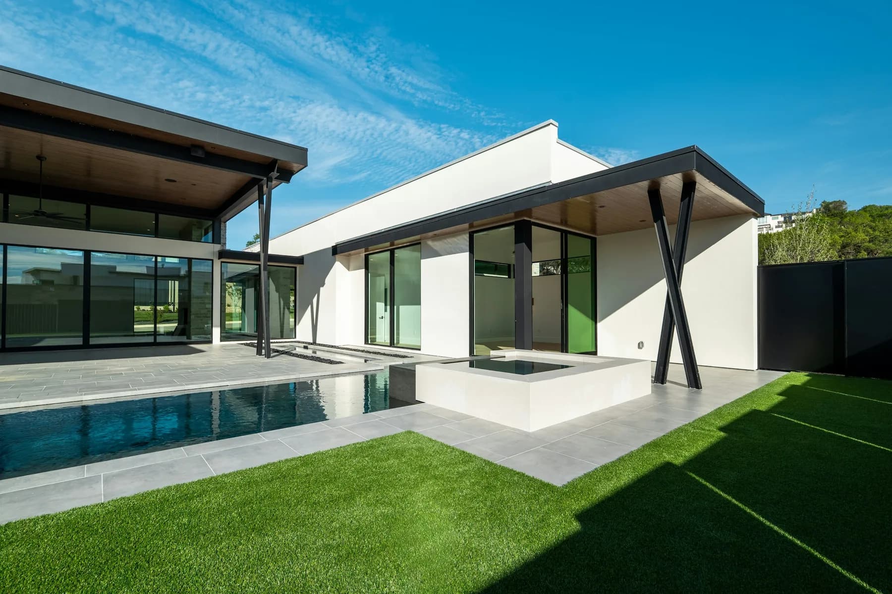 Courtyard view of modern house with pool and lawn
