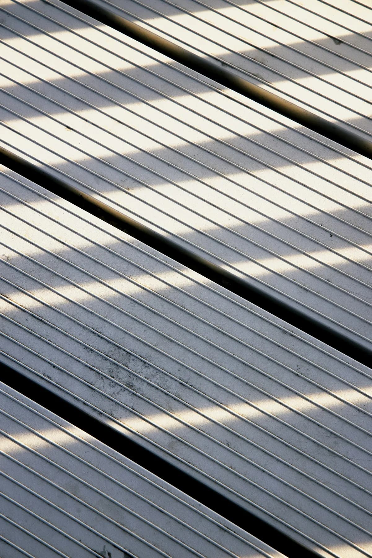 Close-up of grooved grey composite deck boards