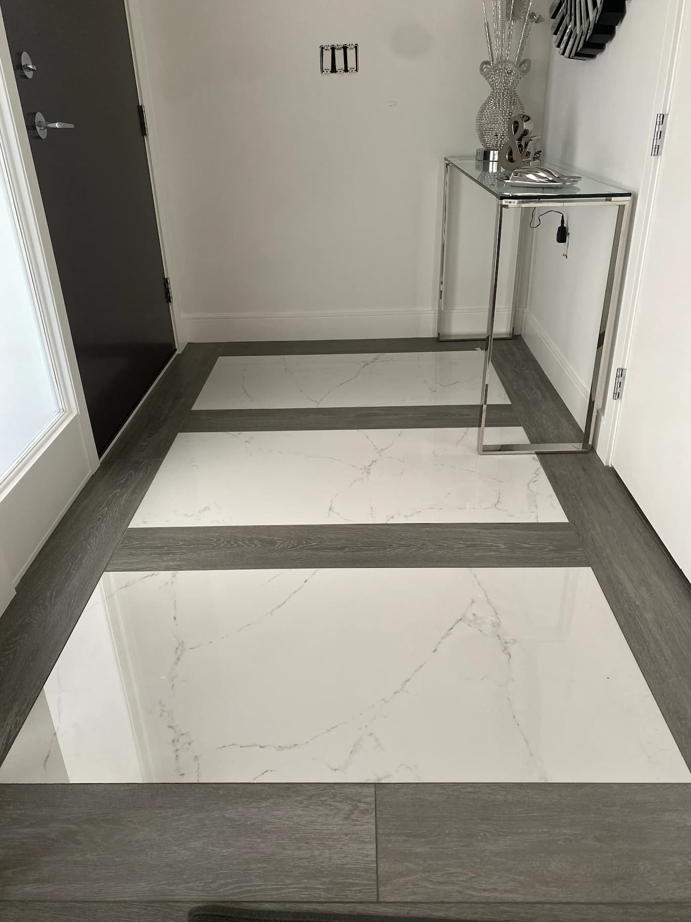 Marble slab flooring with contrasting border in custom front entrance